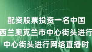 配资股票投资一名中国公民在新西兰奥克兰市中心街头进行网络直播时